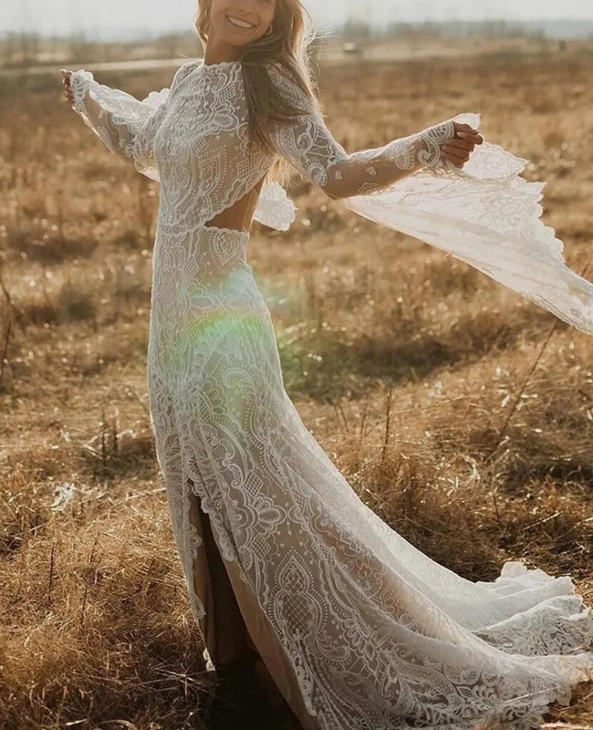 Wildflower Bride’s Dream long-sleeve lace wedding dress in an autumn field