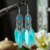 Sbd211db929de4635803e67af3b9f770av.webp Boho Feather Earrings with Vibrant Gemstone Accents