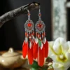 Sda115a96b8964571867140084b93ca44n.webp Boho Feather Earrings with Vibrant Gemstone Accents