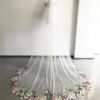 2 The Bellflower Veil, a cathedral wedding veil with three-dimensional embroidered wildflowers along the hem