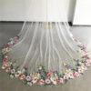 3 The Bellflower Veil, a cathedral wedding veil with three-dimensional embroidered wildflowers along the hem