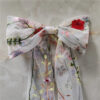 5 The Poppy Bow, a wildflower embroidered wedding hair bow with veil tails on a comb