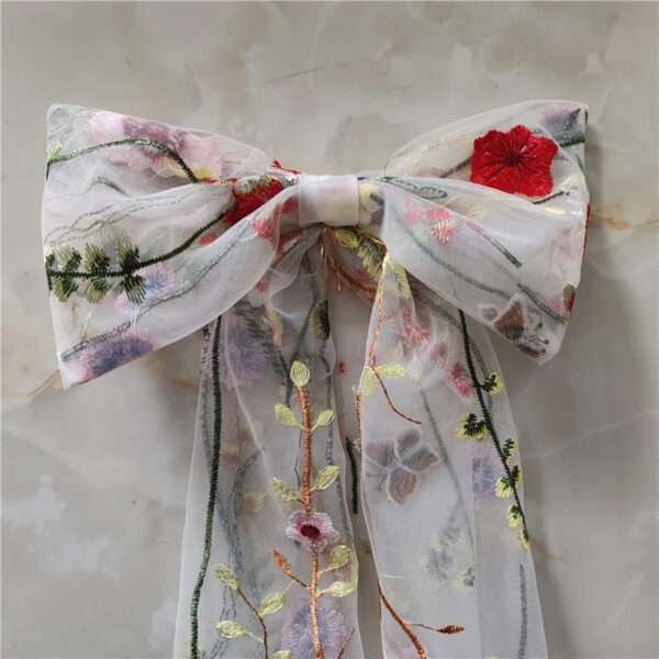 5 The Poppy Bow, a wildflower embroidered wedding hair bow with veil tails on a comb