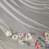 6 The Bellflower Veil, a cathedral wedding veil with three-dimensional embroidered wildflowers along the hem