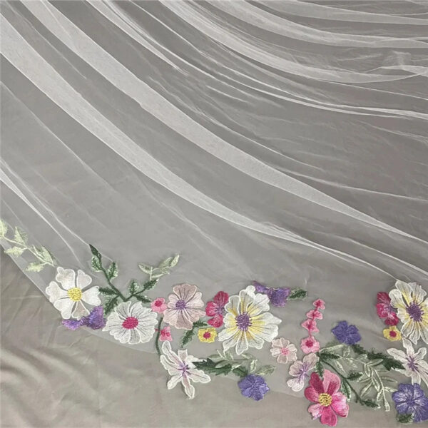 6 The Bellflower Veil, a cathedral wedding veil with three-dimensional embroidered wildflowers along the hem