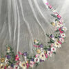 7 The Bellflower Veil, a cathedral wedding veil with three-dimensional embroidered wildflowers along the hem