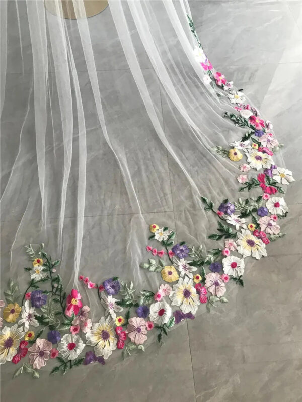 7 The Bellflower Veil, a cathedral wedding veil with three-dimensional embroidered wildflowers along the hem