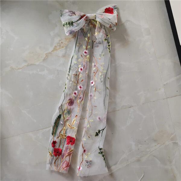 7 The Poppy Bow in Red Flowers, an embroidered wedding hair bow with long veil tails