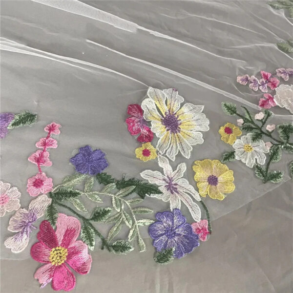 9 The Bellflower Veil, a cathedral wedding veil with three-dimensional embroidered wildflowers along the hem