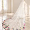 Embroidered Veil in Sunlit Bridal Studio The Bellflower Veil, a cathedral wedding veil with three-dimensional embroidered wildflowers along the hem