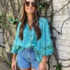 H0bfbc603db0d447ca4f84973e058ec66R.webp Rhapsody Button-Down Boho Floral Blouse with Tassel Ties