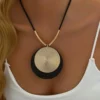 S05fdb06f47e2493e919524534b977844Y.webp Dynamic Circular Necklace with Textured Gold and Black Pendant