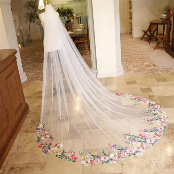 S0c2f8cc95ece4ecbaeca346e3d7bcc54W.webp The Bellflower Veil, a cathedral wedding veil with three-dimensional embroidered wildflowers along the hem
