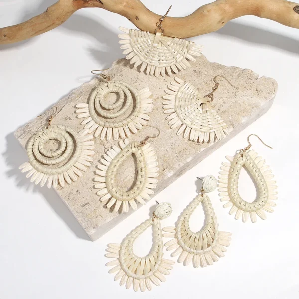 S0d20398053804a6680863278c33d56ccK.webp Textured raffia statement earrings styled as a woven trio