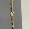 S1a38effd21ed4476bbfe9b8607ae42a7L.webp Elysian Gemstone Embellished Wristwatch with Bracelet Strap