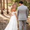 Back view of a draped off-shoulder boho wedding dress with crochet lace and waist cutouts