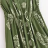 S212b8a094bbc4f41909b826ac68e26c8o.webp Desert Bloom: Floral Print Backless Halter Maxi with Tassel Hem