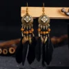 S22b7a46bd6a54ac8b08e28a1f67b74c7E.webp Nomad Sun Feather Dreamcatcher Statement Earrings