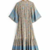 S2ba0c73683874d109e08e7d17676c515a.webp Free Spirit Bohemian Dress with Flowing Sleeves and Floral Detail