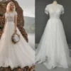 Boat neckline and beaded tassel fringe sleeves on a boho tulle wedding dress