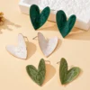 S2dc485d80a58424caadc19983a0c7656r.webp Sculpted Heart Statement Earrings