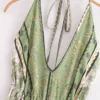 S33520a195f264c01bd553bfc3ad82285n.webp Desert Bloom: Floral Print Backless Halter Maxi with Tassel Hem
