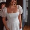 Close view of the square neckline and sheer organza puff sleeves on an ivory bridal gown