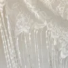 The Alba Veil, an ivory tassel fringe wedding veil in floral lace with a scalloped border