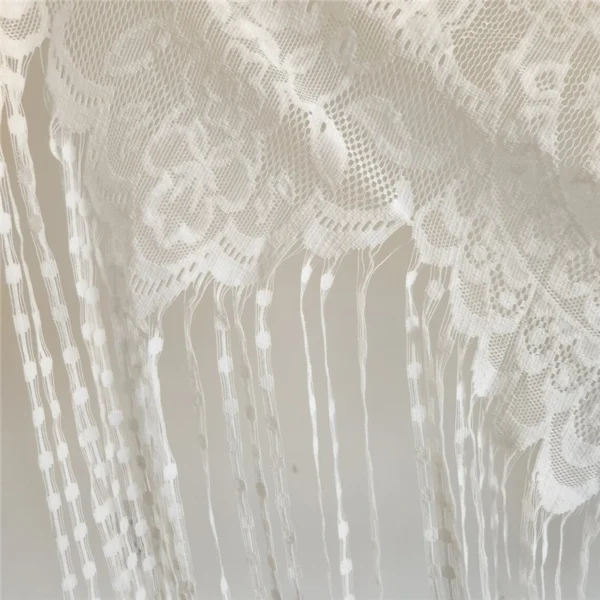 The Alba Veil, an ivory tassel fringe wedding veil in floral lace with a scalloped border