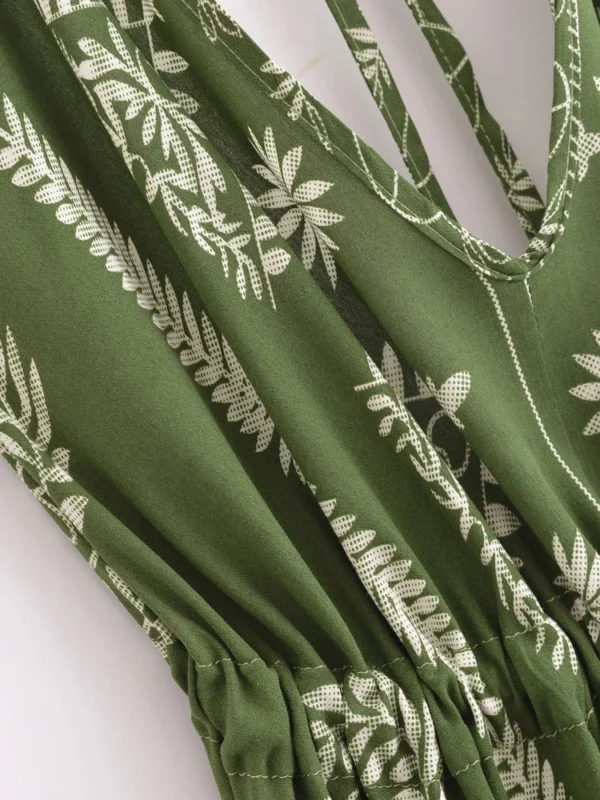 S64026149083c4ecf978056be7cf94bf4E.webp Desert Bloom: Floral Print Backless Halter Maxi with Tassel Hem