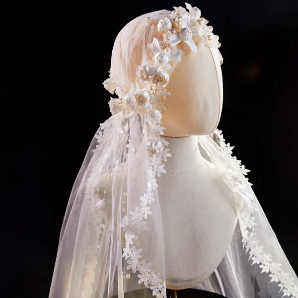 The Elsie Cap, a cream white juliet cap veil with 3D fabric flowers, pearls and a lace-edged tulle veil