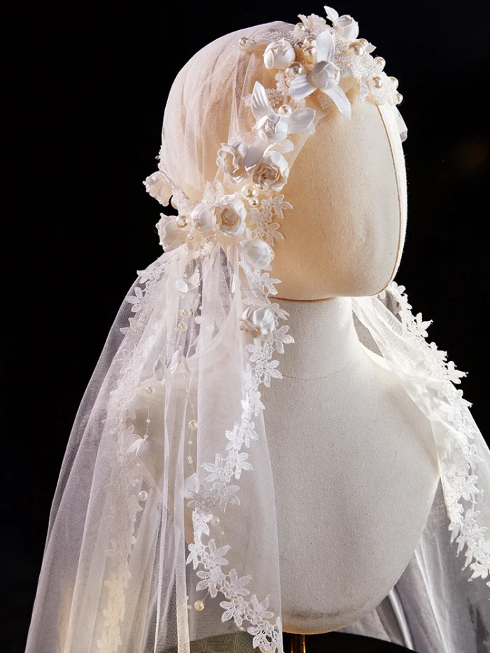 The Elsie Cap, a cream white juliet cap veil with 3D fabric flowers, pearls and a lace-edged tulle veil