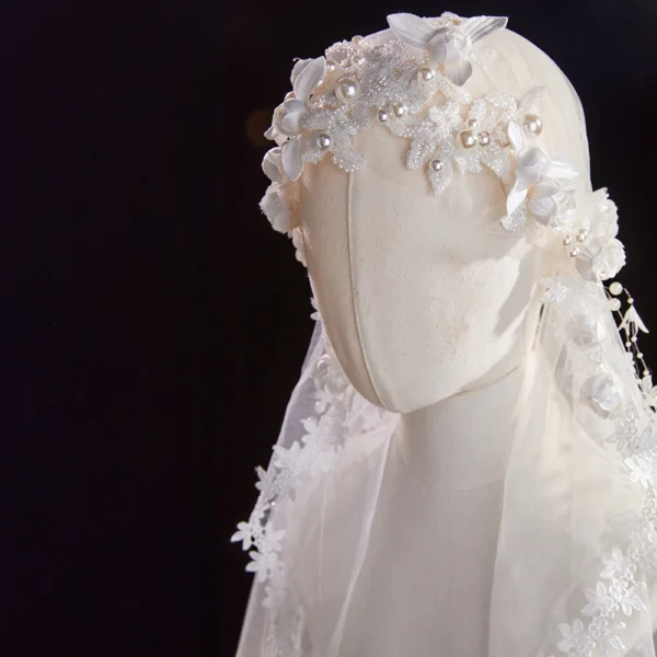 The Elsie Cap, a cream white juliet cap veil with 3D fabric flowers, pearls and a lace-edged tulle veil