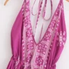 S7c9c0eeddbd34463b16f09cf94366886C.webp Desert Bloom: Floral Print Backless Halter Maxi with Tassel Hem