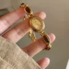 S8180d68f64e743e1a42a56319f78ca19H.webp Elysian Gemstone Embellished Wristwatch with Bracelet Strap