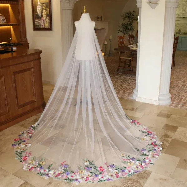 S818b9637716c4941a649a817e2993a4e1.webp The Bellflower Veil, a cathedral wedding veil with three-dimensional embroidered wildflowers along the hem