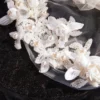 The Elsie Cap, a cream white juliet cap veil with 3D fabric flowers, pearls and a lace-edged tulle veil