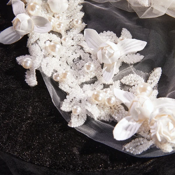 The Elsie Cap, a cream white juliet cap veil with 3D fabric flowers, pearls and a lace-edged tulle veil