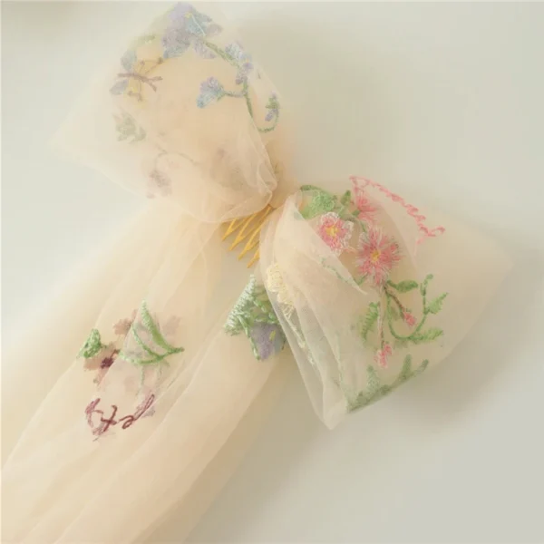 S8ff918c823744e3d94a81fe32df890f43.webp Romantic Whispers Bow Veil With Comb featured in Floral Embroidery