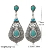 S90aaf2d2bb57472ba5d89e08e9a13e3e1.webp Intricate Silver Boho Earrings with Turquoise Accents