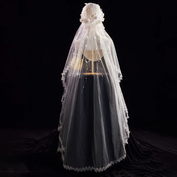The Elsie Cap, a cream white juliet cap veil with 3D fabric flowers, pearls and a lace-edged tulle veil
