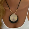 Sb88b6cabd9e24d1ebd39f30fb882ac08y.webp Dynamic Circular Necklace with Textured Gold and Black Pendant