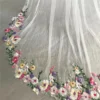 Sbe69d9e0e76c4fa6b111eb2a30b13197R.webp The Bellflower Veil, a cathedral wedding veil with three-dimensional embroidered wildflowers along the hem