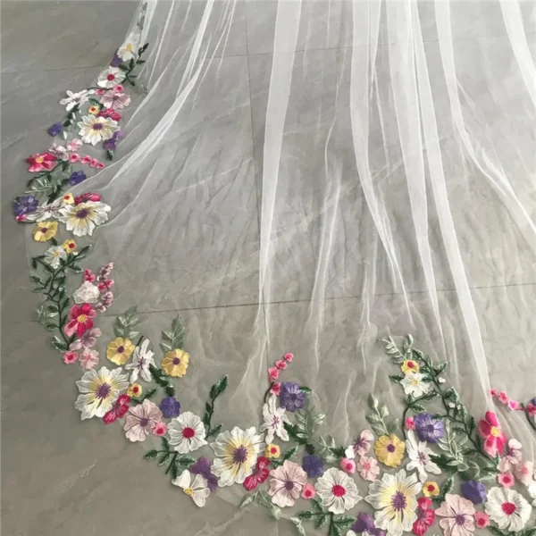 Sbe69d9e0e76c4fa6b111eb2a30b13197R.webp The Bellflower Veil, a cathedral wedding veil with three-dimensional embroidered wildflowers along the hem
