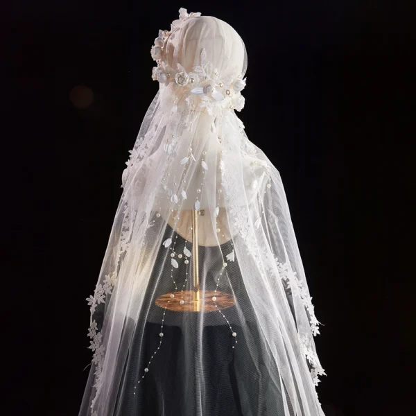 The Elsie Cap, a cream white juliet cap veil with 3D fabric flowers, pearls and a lace-edged tulle veil