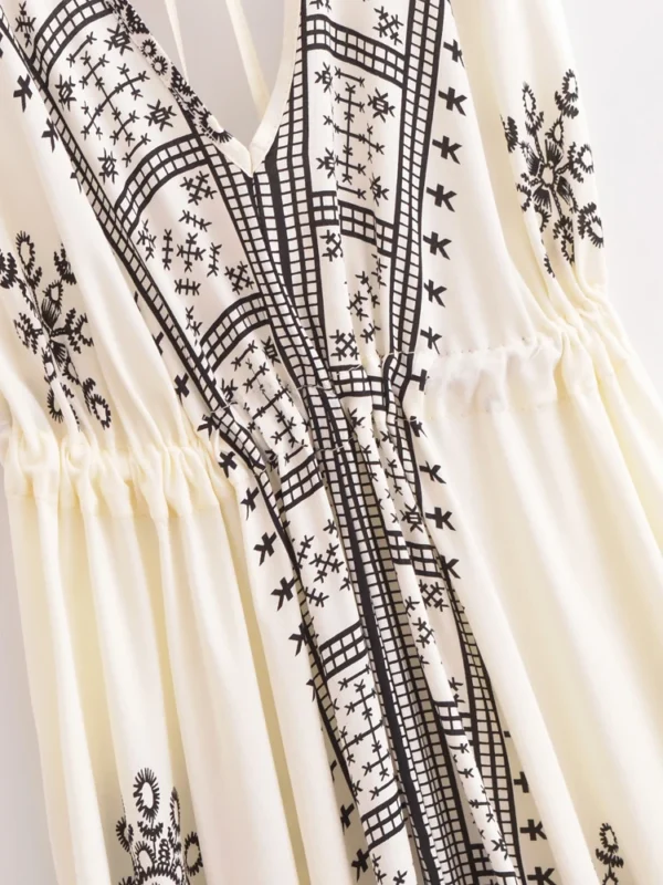 Sd132cca44a6d4ba1ab01b5b3df8fd2b7K.webp Desert Bloom: Floral Print Backless Halter Maxi with Tassel Hem