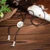 Sda913106cf074a05b9f30c65407b5233K.webp Frontier Adventure Western Bolo Tie with Hat and Boot Accents