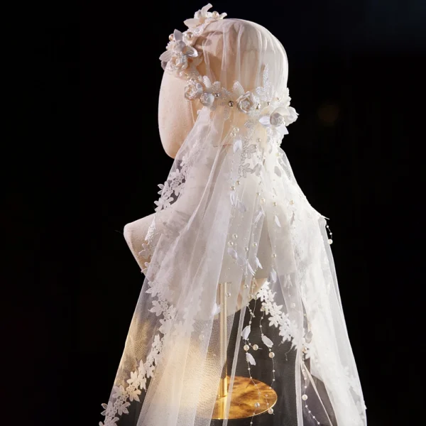 The Elsie Cap, a cream white juliet cap veil with 3D fabric flowers, pearls and a lace-edged tulle veil