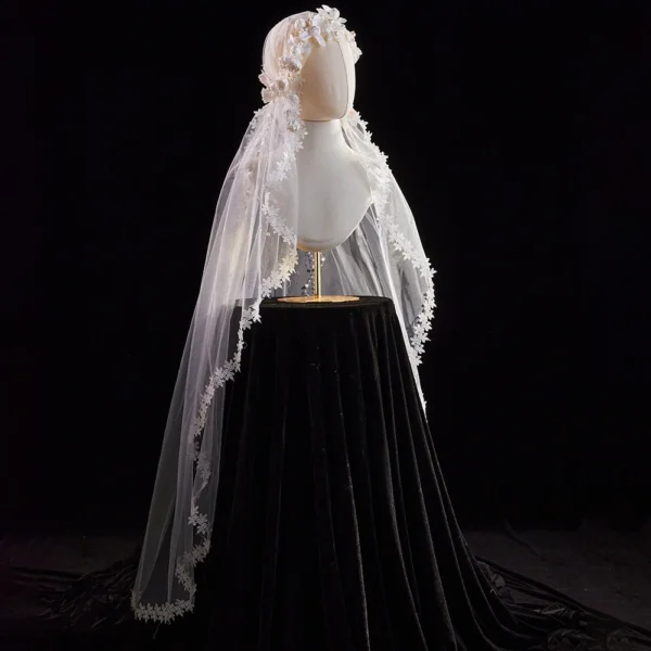 The Elsie Cap, a cream white juliet cap veil with 3D fabric flowers, pearls and a lace-edged tulle veil