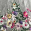 Secdfcc98cb6d489da51ee25b532cb8d2d.webp The Bellflower Veil, a cathedral wedding veil with three-dimensional embroidered wildflowers along the hem